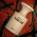 FUGAZZI Eau de Parfum bottle by BORNTOSTANDOUT showcasing its elegant design on a colorful background.