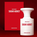 Sugar Addict Eau de Parfum bottle and packaging against a bold red background, showcasing its luxurious sweet fragrance.